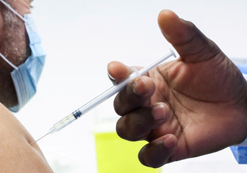FILE PHOTO: People receive a booster dose of coronavirus disease (COVID-19) vaccine in Brussels