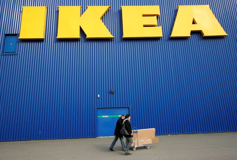 FILE PHOTO: People push a shopping cart past a warehouse of the Swedish furniture maker IKEA in Bordeaux