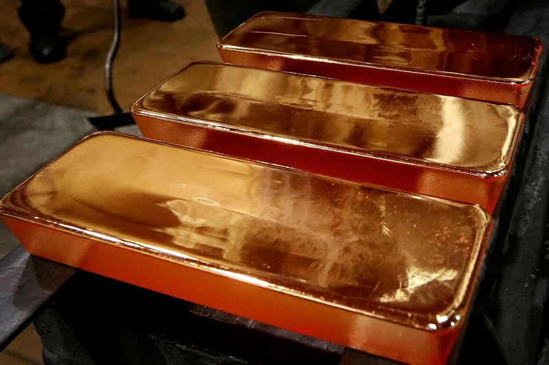FILE PHOTO: Employees process ingots of 99.99 percent pure gold at the Krastsvetmet non-ferrous metals plant in the Siberian city of Krasnoyarsk