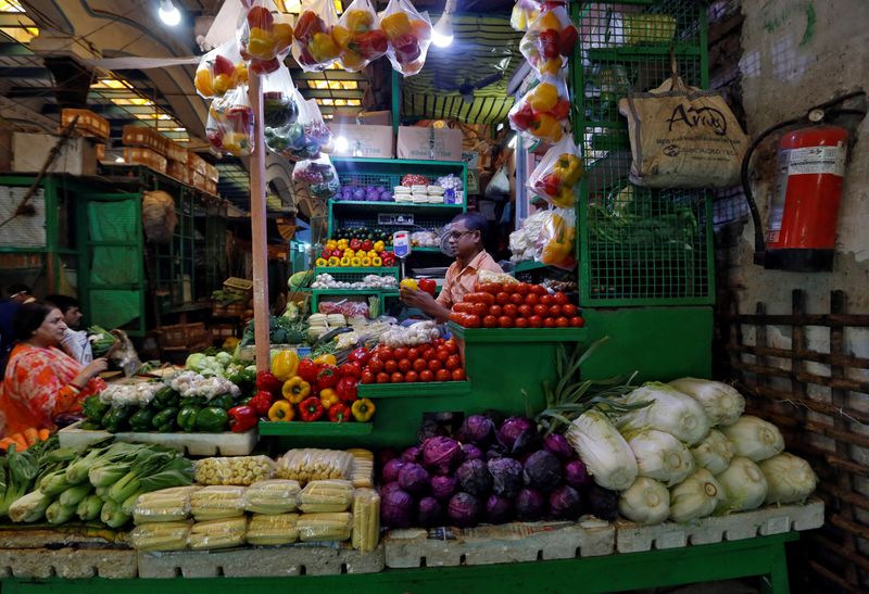A vendor sells vegetables at a retail market in Kolkata