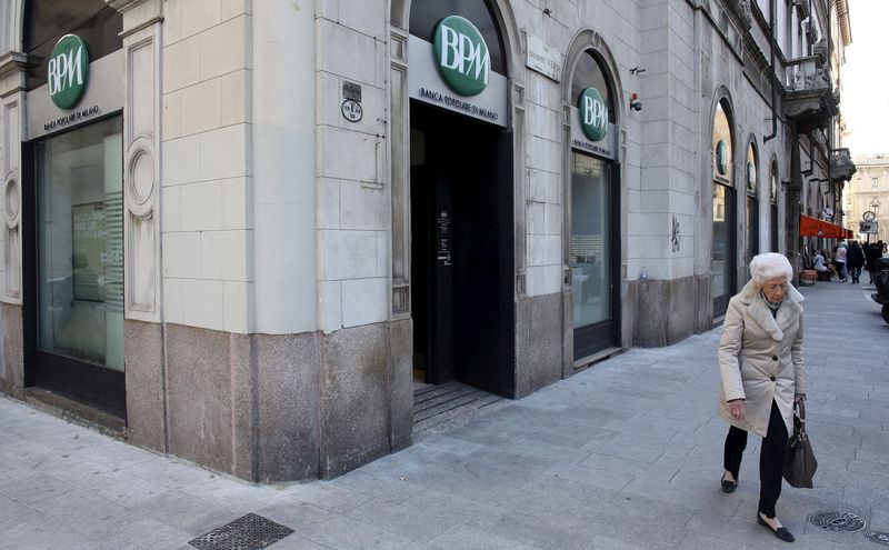 FILE PHOTO: A woman walks past Banca Popolare di Milano ( BPM) downtown Milan