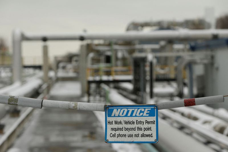FILE PHOTO: Warning sign is seen with transfer lines at Dominion Cove Point Liquefied Natural Gas terminal in Maryland