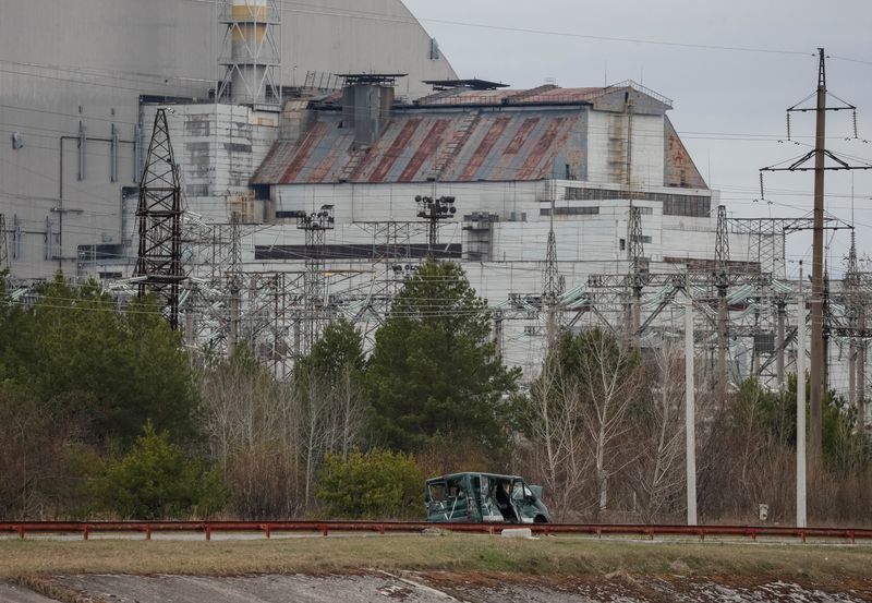 A destroyed car marked with the letter ''V'' is seen near the New Safe Confinement structure over the old sarcophagus covering the damaged fourth reactor at the Chornobyl Nuclear Power Plant, in Chornobyl