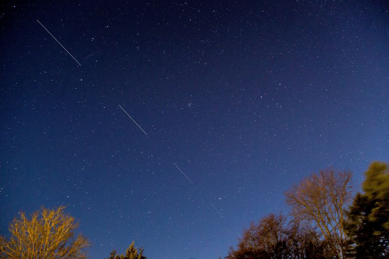 FILE PHOTO: SpaceX Starlink 5 satellites are pictured in the sky seen from Svendborg