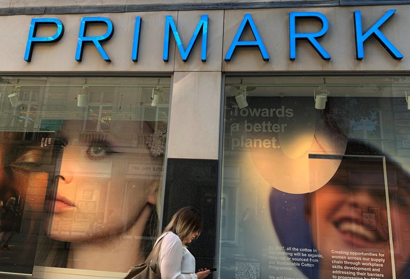 FILE PHOTO: A woman walks past a window display at a Primark store in Liverpool