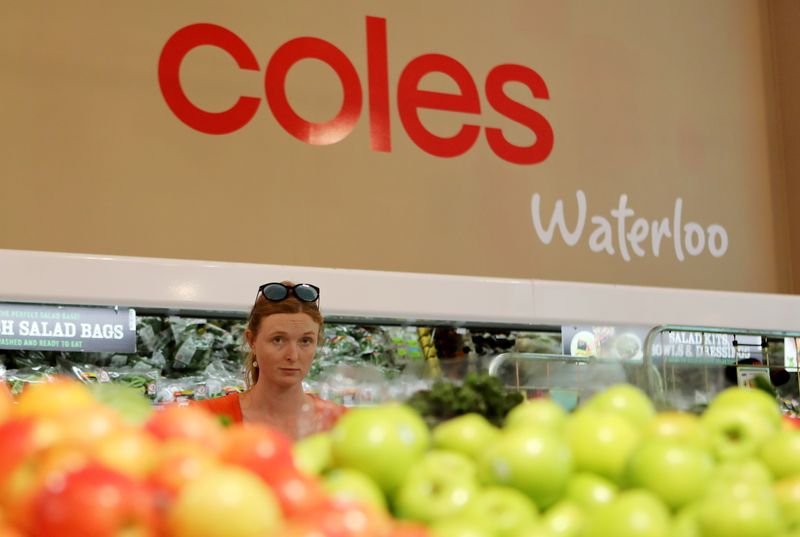 FILE PHOTO: A woman walks in the fruit and vegetables section at a Coles supermarket (main Wesfarmers brand) in Sydney