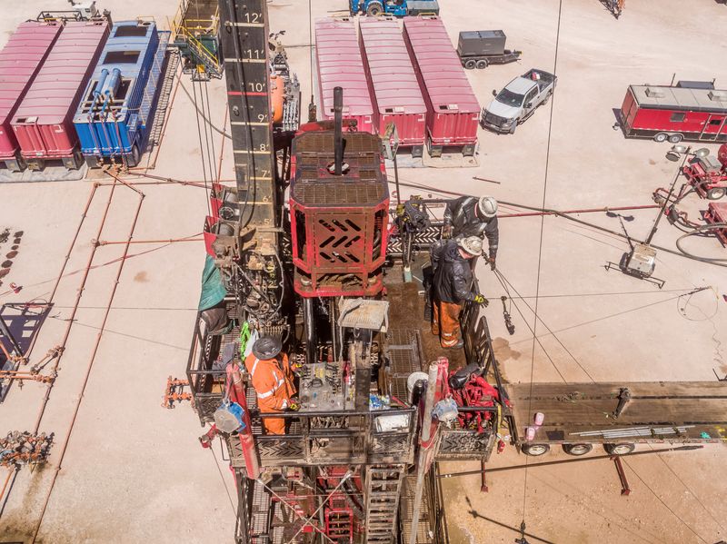 FILE PHOTO: An overview photo of Deep Well Services based field employees working in the Snubbing basket of a 300K 15M Hydraulic Completion Unit (HCU), in Texas