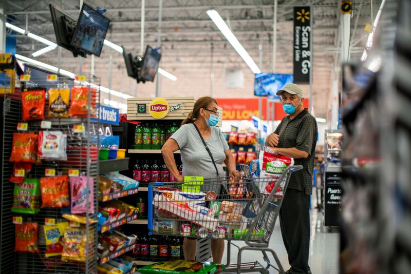 FILE PHOTO: Shoppers are seen wearing masks while shopping at a Walmart store, in North Brunswick, New Jersey