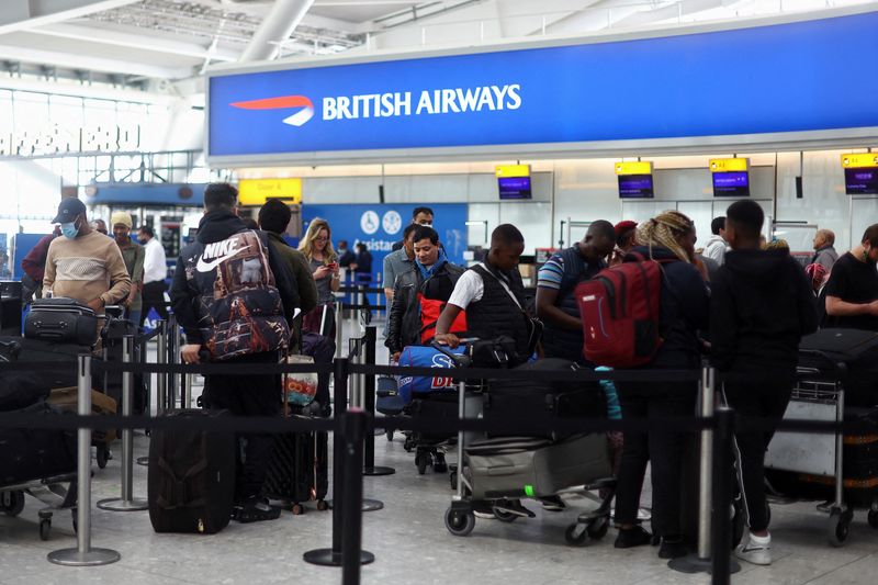 FILE PHOTO: People prepare to travel for Easter Bank Holiday weekend, at Heathrow Airport in London, Britain