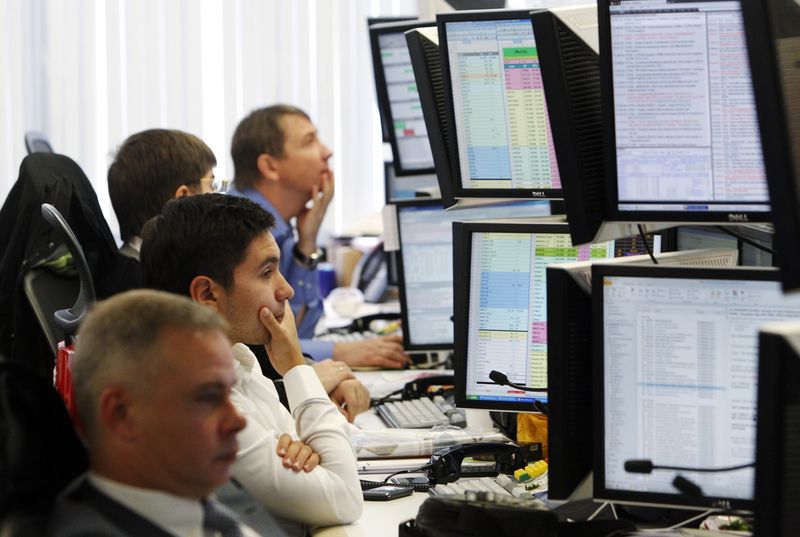 Trader watch their screens on the Troika Dialog trading floor in Moscow