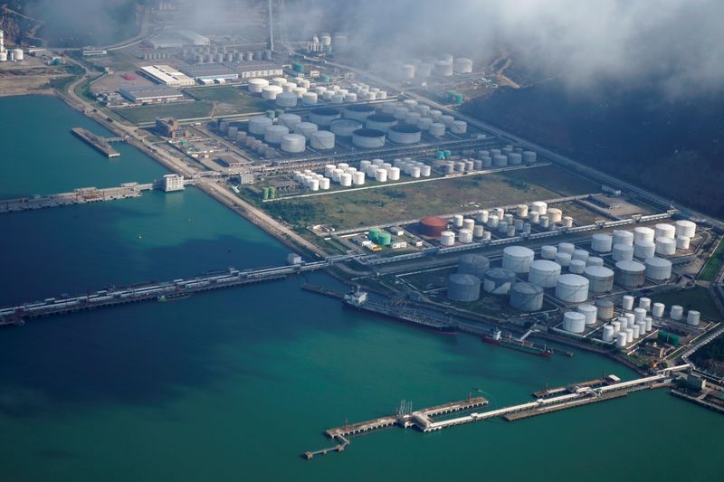 FILE PHOTO: Oil and gas tanks are seen at an oil warehouse at a port in Zhuhai, China