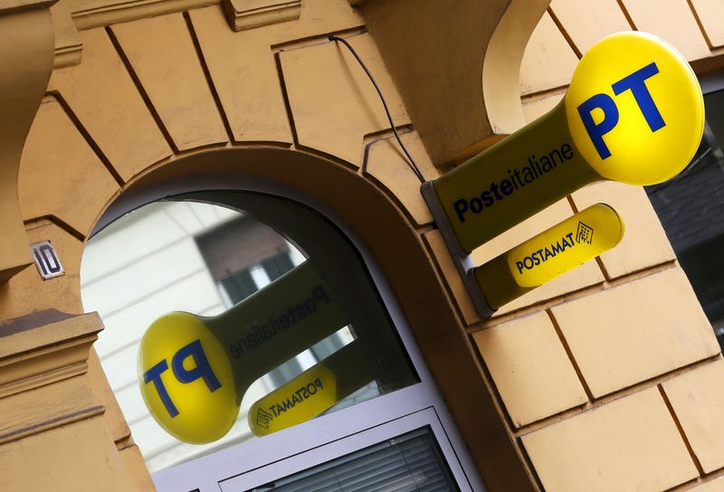 FILE PHOTO: A signboard of Poste Italiane is seen hanging outside a post office in Rome