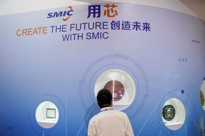 A man visits a booth of Semiconductor Manufacturing International Corporation (SMIC), at China International Semiconductor Expo (IC China 2020) following the coronavirus disease (COVID-19) outbreak in Shanghai