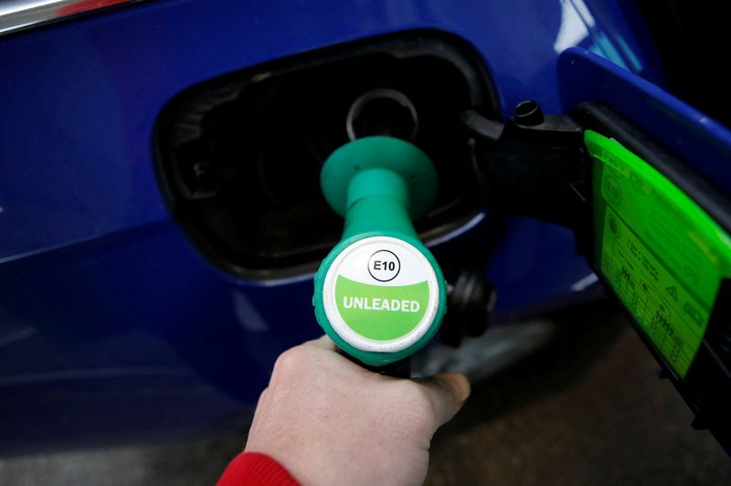 FILE PHOTO: A motorist fills his car with the new E10 grade of unleaded petrol at a filling station in Liverpool