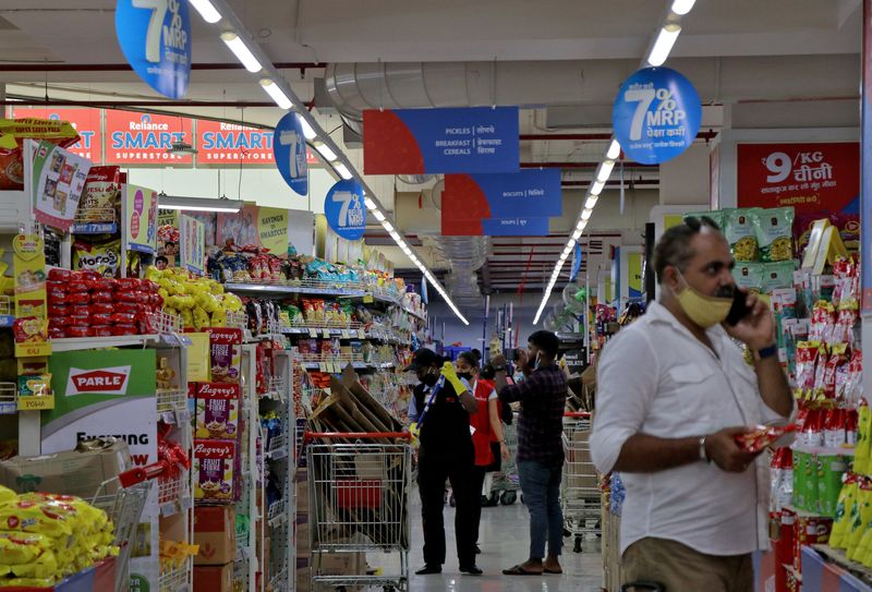 FILE PHOTO: Customers buy grocery items inside a superstore of Reliance Industries Ltd, in Mumbai