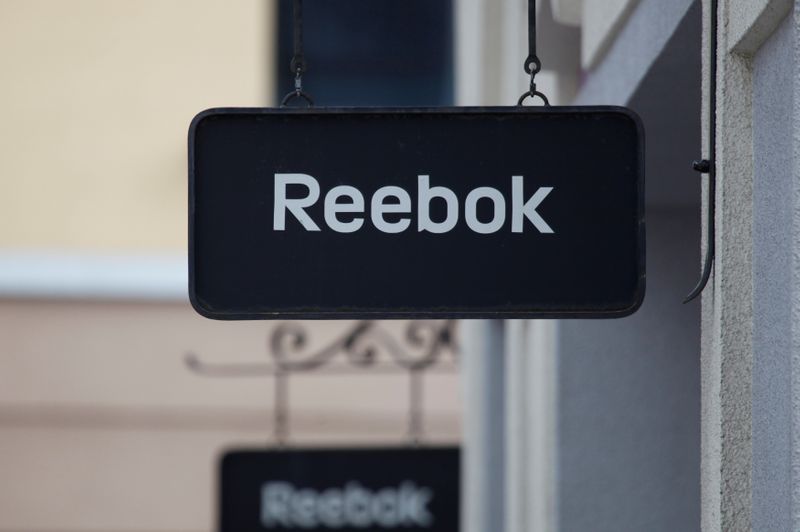 FILE PHOTO: Boards with Reebok store logo are seen on a shopping center at the outlet village Belaya Dacha outside Moscow