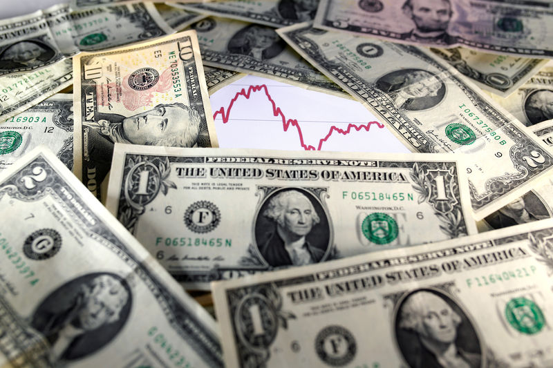 FILE PHOTO: U.S. dollar notes are seen in front of a stock graph in this picture illustration