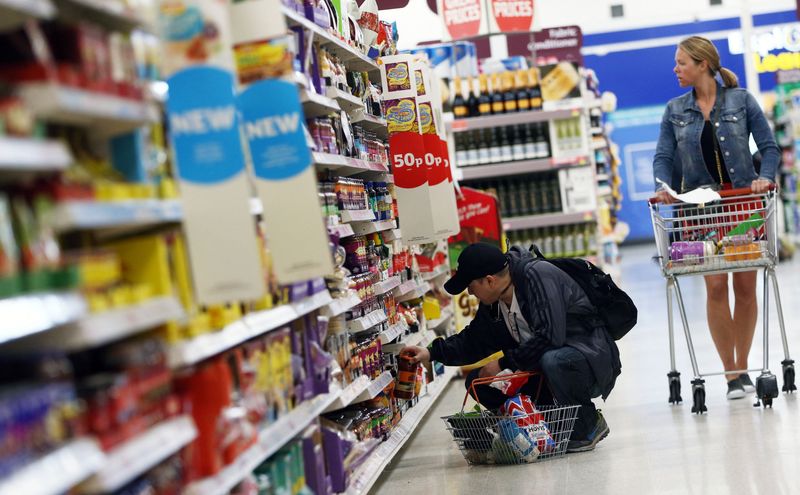 Shoppers browse aisles in a supermarket in London