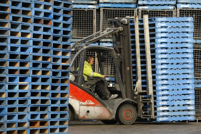 Forklift operator moves stack of pallets at Brambles-owned CHEP pallet depot in Sydney