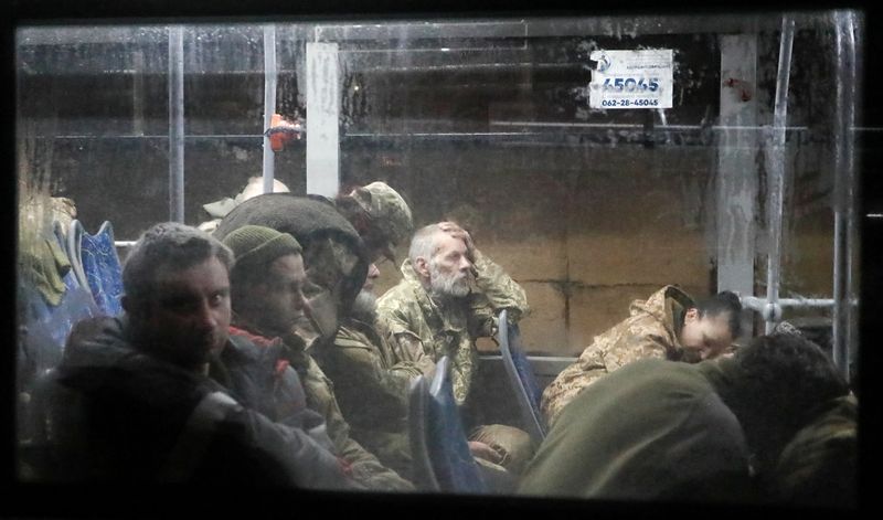 Buses carrying Ukrainian Azovstal service members arrive in Olenivka