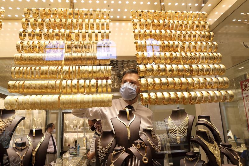 FILE PHOTO: A goldsmith arranges golden bangles at a jewellery shop, in Istanbul