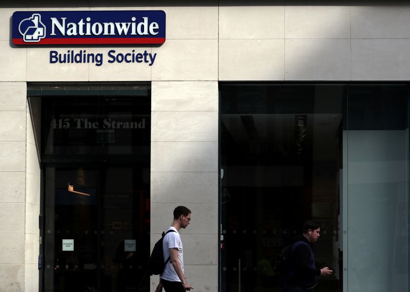 FILE PHOTO: A man walks past a Nationwide Building Society in London