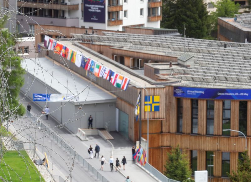 People walk past the congress center, the venue of the World Economic Forum 2022 in Davos