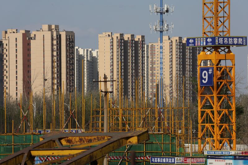 Residential buildings  are pictured near a construction site in Beijing