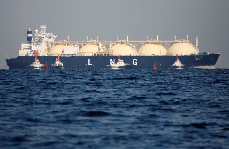 FILE PHOTO: An LNG tanker is tugged towards a thermal power station in Futtsu