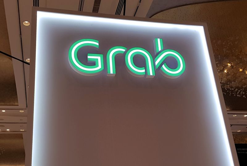 FILE PHOTO: A Grab logo is pictured at the Money 20/20 Asia Fintech Trade Show in Singapore
