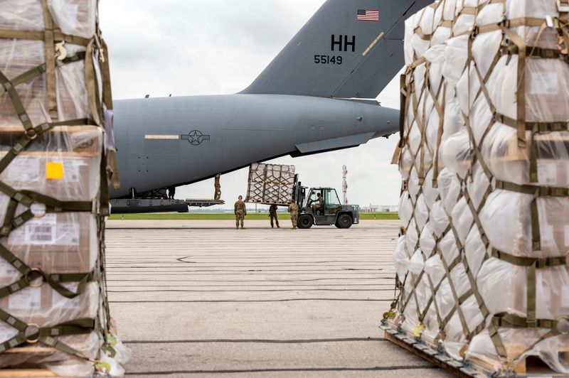 FILE PHOTO: Crew members of an Air Force C-17 aircraft unload Nestle baby formula after its arrival from Ramstein Air Base