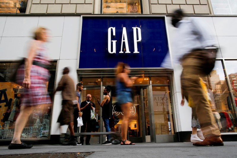 FILE PHOTO: People pass by the GAP clothing retail store in Manhattan, New York