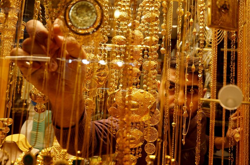 An Iraqi goldsmith arranges gold at his shop in Najaf