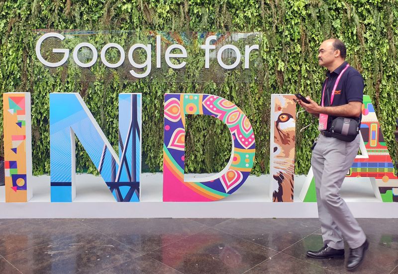 FILE PHOTO: A man walks past the sign 'Google for India' at the company's annual technology event in New Delhi