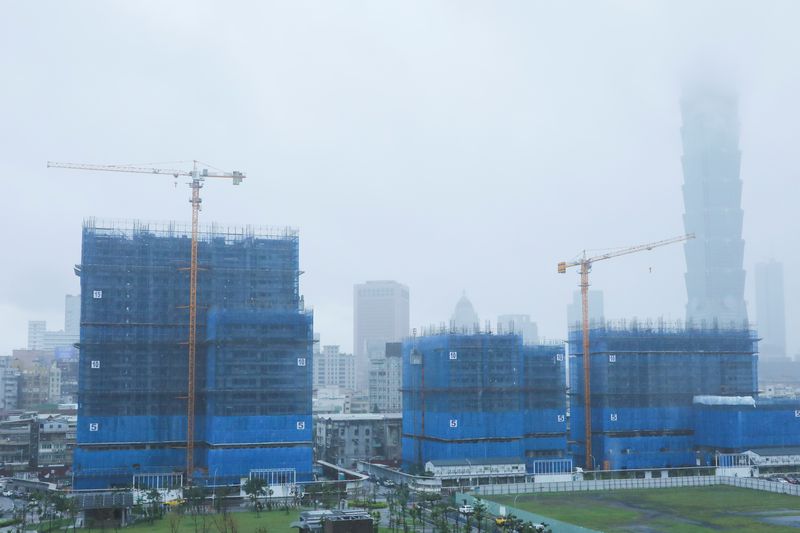 Cranes are pictured during a rainy day at a construction site in Taipei