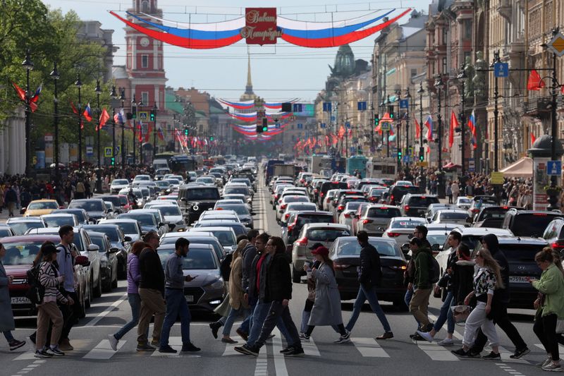 FILE PHOTO: Pedestrians walk across Nevsky Avenue in central Saint Petersburg