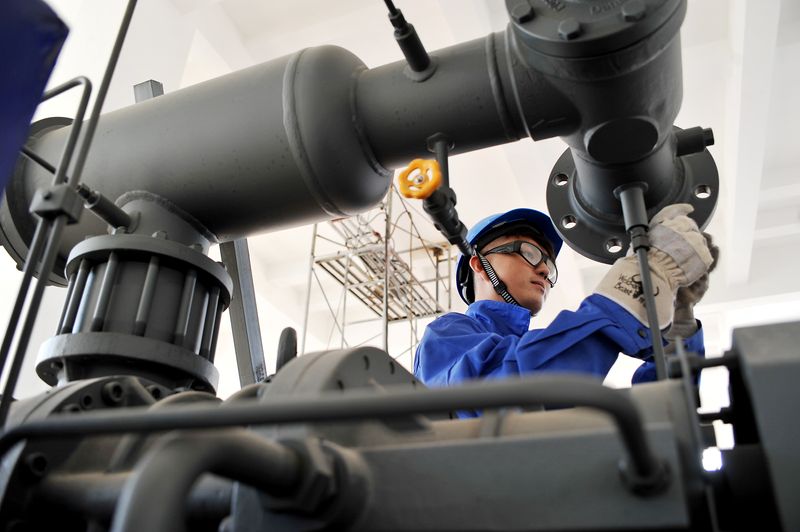 Worker installs equipment at a Tsingtao Brewery industrial park in Zhangjiakou