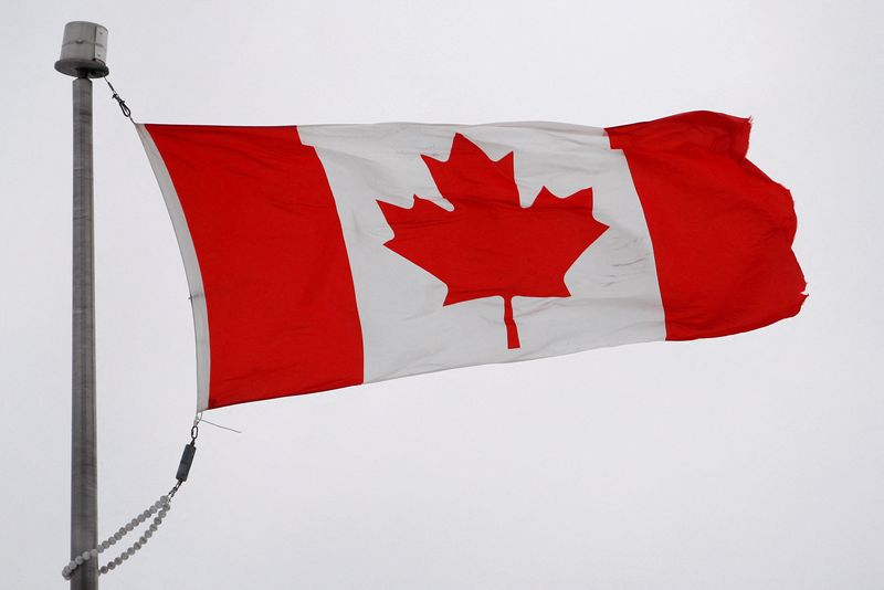FILE PHOTO: The Canadian flag flutters in the wind in Quebec City