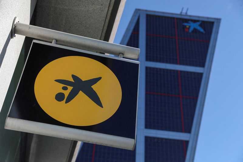 FILE PHOTO: A CaixaBank branch logo is seen next to CaixaBank headquarters in Madrid