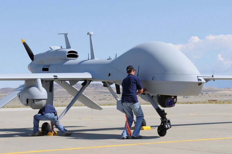 FILE PHOTO: Workers prepare an MQ-1C Gray Eagle unmanned aerial vehicle for static display at Michael Army Airfield, Dugway Proving Ground in Utah in this US Army handout photo
