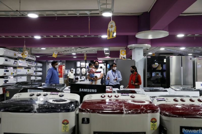 FILE PHOTO: A customer with his family is seen at an electronics and appliances shop in Jaipur