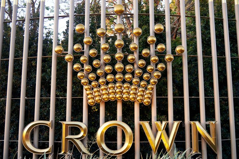 FILE PHOTO: The logo of Australian casino operator Crown Resorts adorns a fence surrounding the Crown Perth hotel and casino complex in Western Australia
