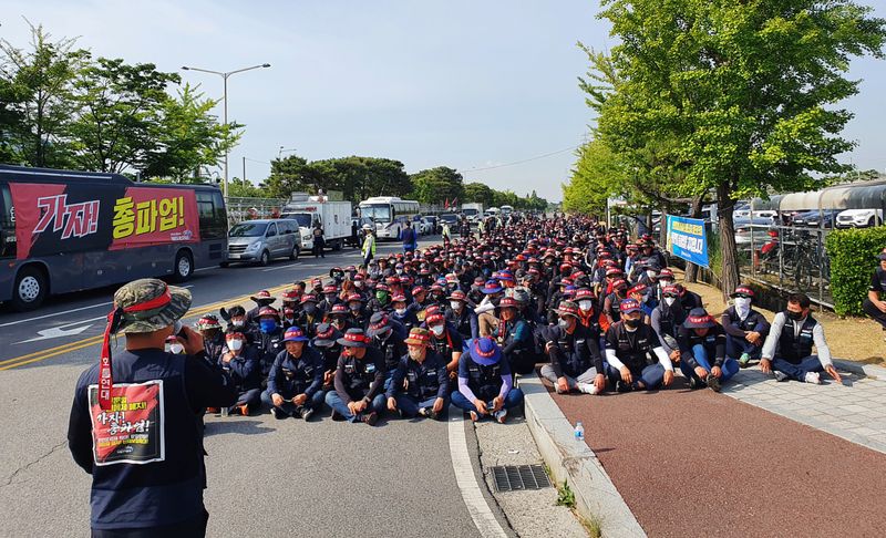 Members of the Cargo Truckers Solidarity union attend a protest in front of Hyundai Motor's factory in Ulsan
