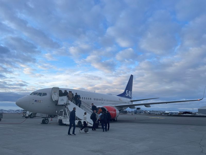 Passengers board a SAS Scandinavian Airlines plane in the Norwegian Arctic town of Kirkenes