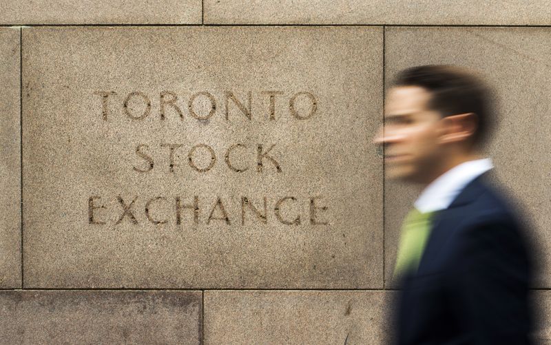 FILE PHOTO: A man walks past an old Toronto Stock Exchange sign in Toronto
