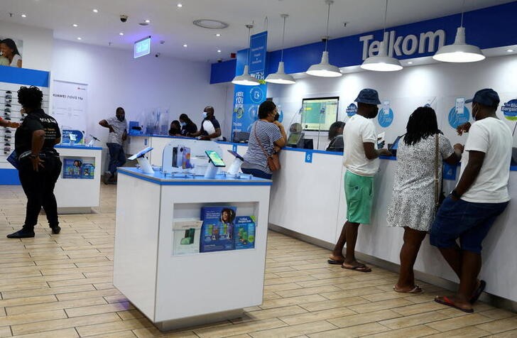 FILE PHOTO: Customers are served at a branch of South Africa's mobile operator, Telkom, in Johannesburg