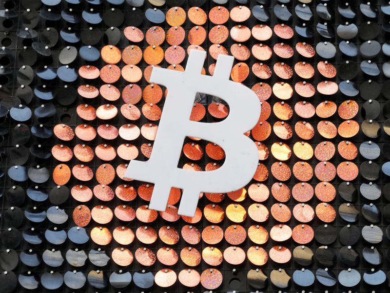 FILE PHOTO: The logo of the Bitcoin digital currency is seen in a shop in Marseille