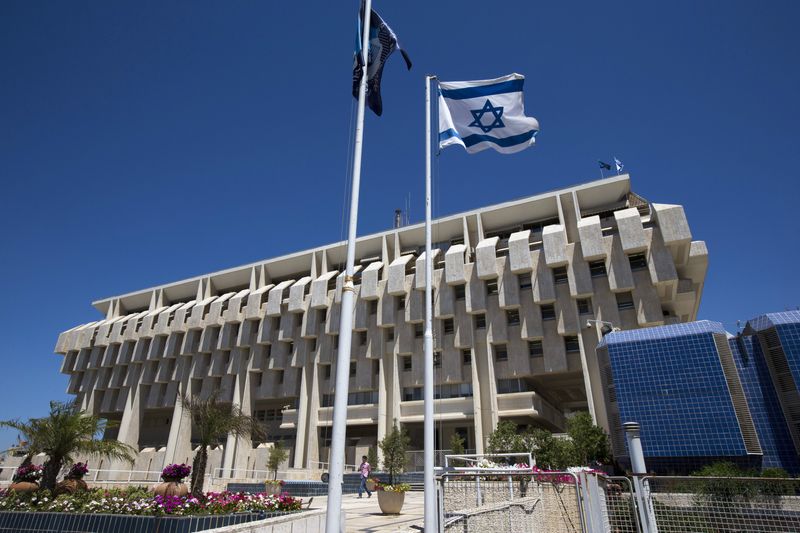 FILE PHOTO: An Israeli flag flutters outside the Bank of Israel building in Jerusalem