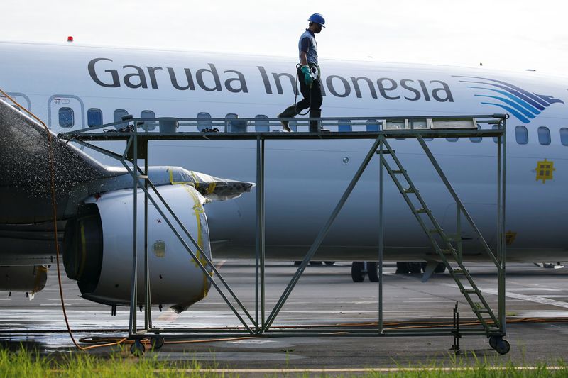 A worker walks on crane at GMF AeroAsia, near Jakarta