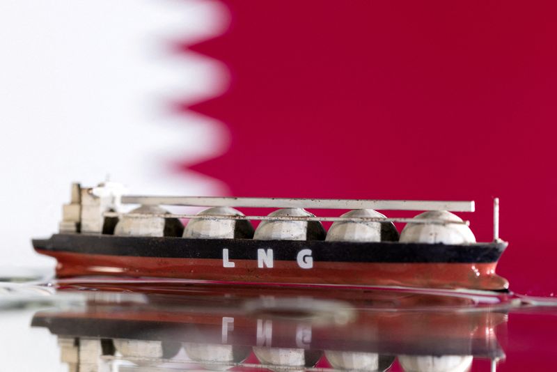 FILE PHOTO: Illustration shows model of LNG tanker and Qatar's flag